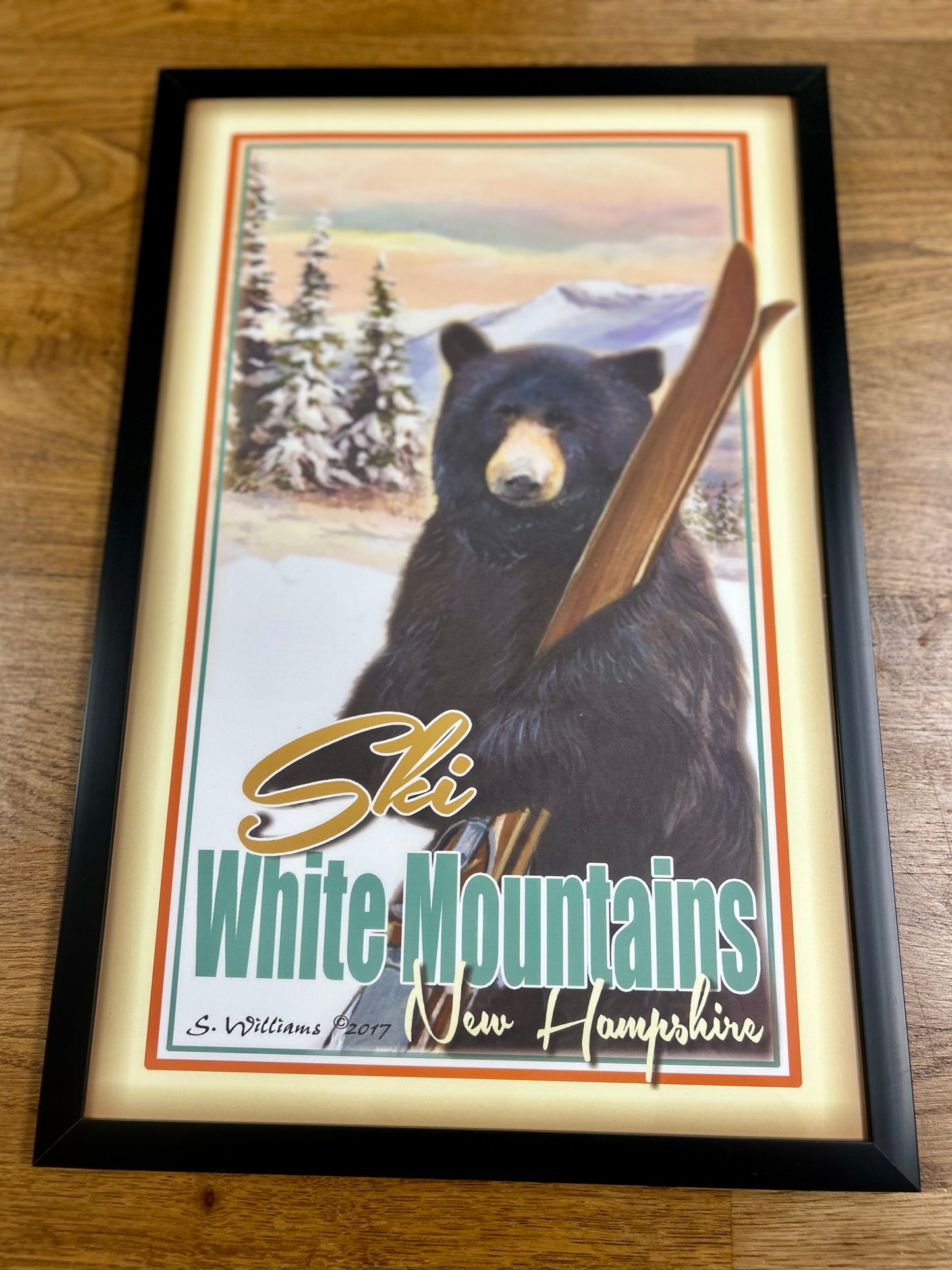 Black bear with wooden skis print. The White Mountains is home to ski areas including Attitash Mountain Resort, Wildcat, Cannon Mountain, and Loon Mountain. Created in Maine from an original painting.