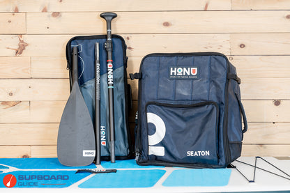 Honu Seaton with paddle and pump packed compactly in travel bags. Photo by supboard guide